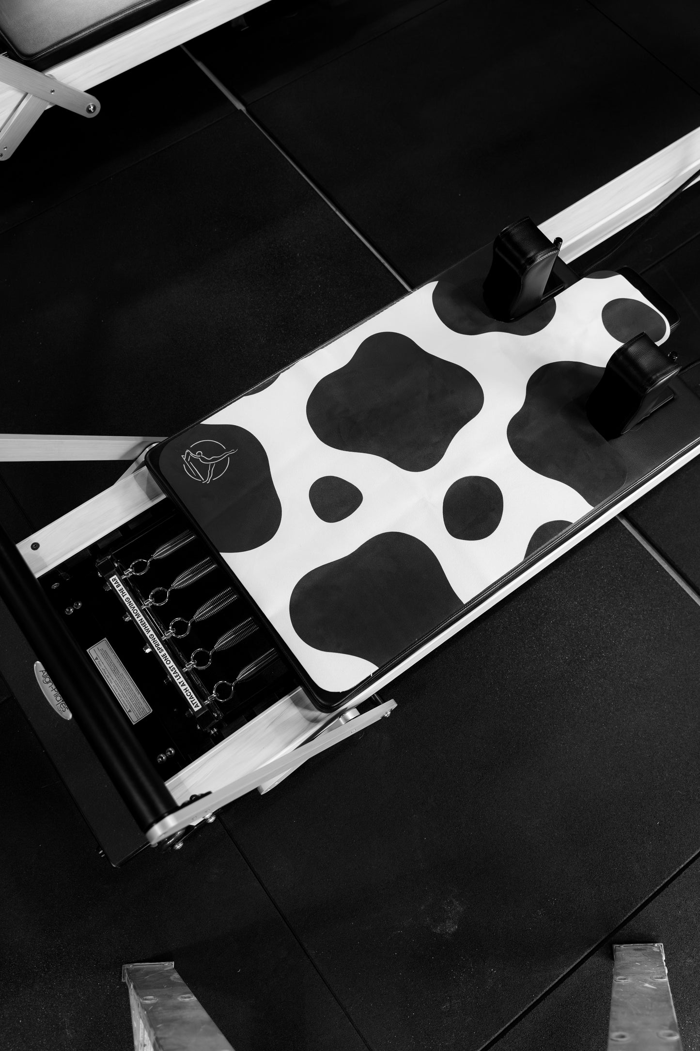 Black and white cow print reformer mat
